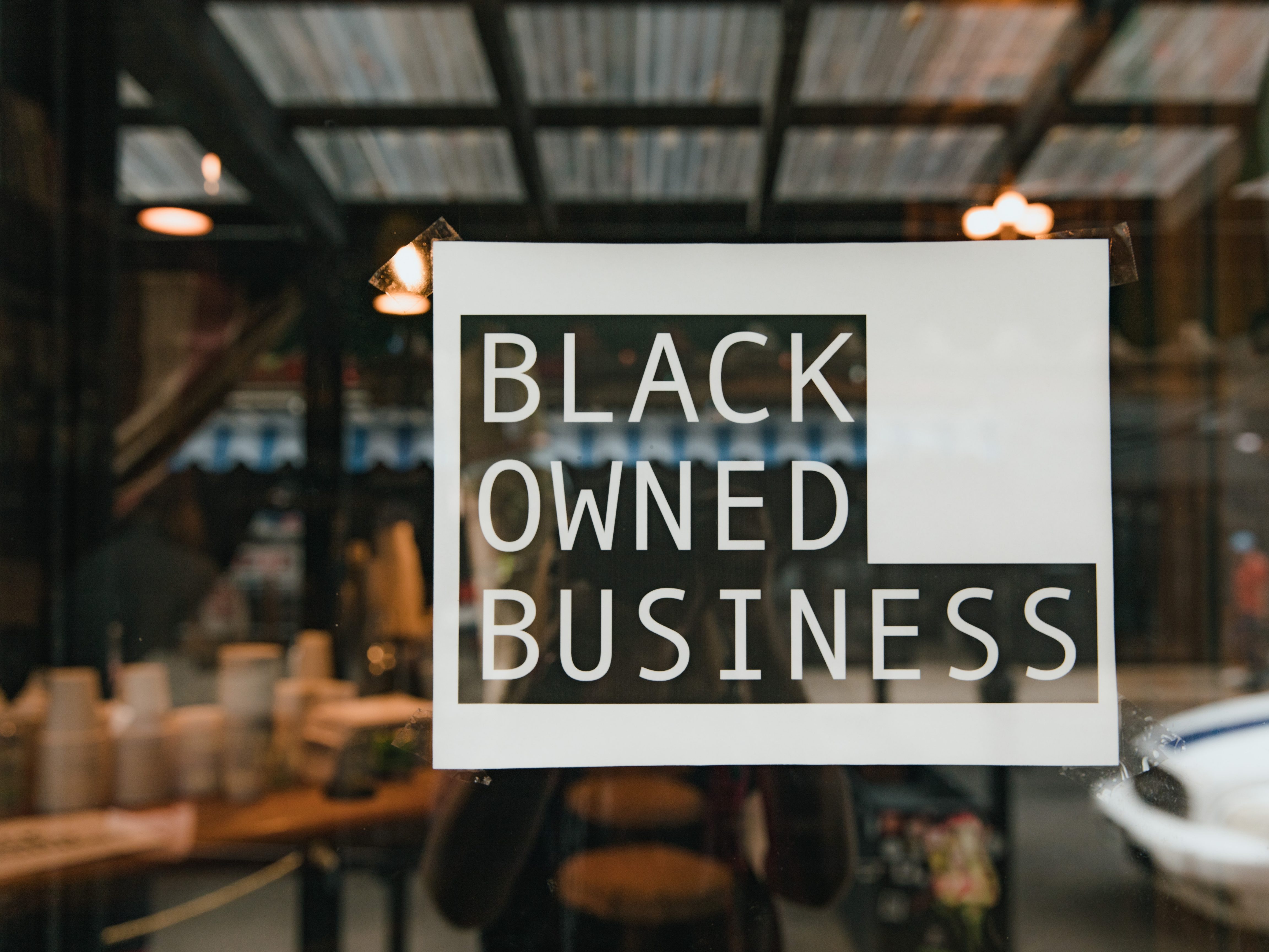 Black Owned Business sign displayed on a storefront window