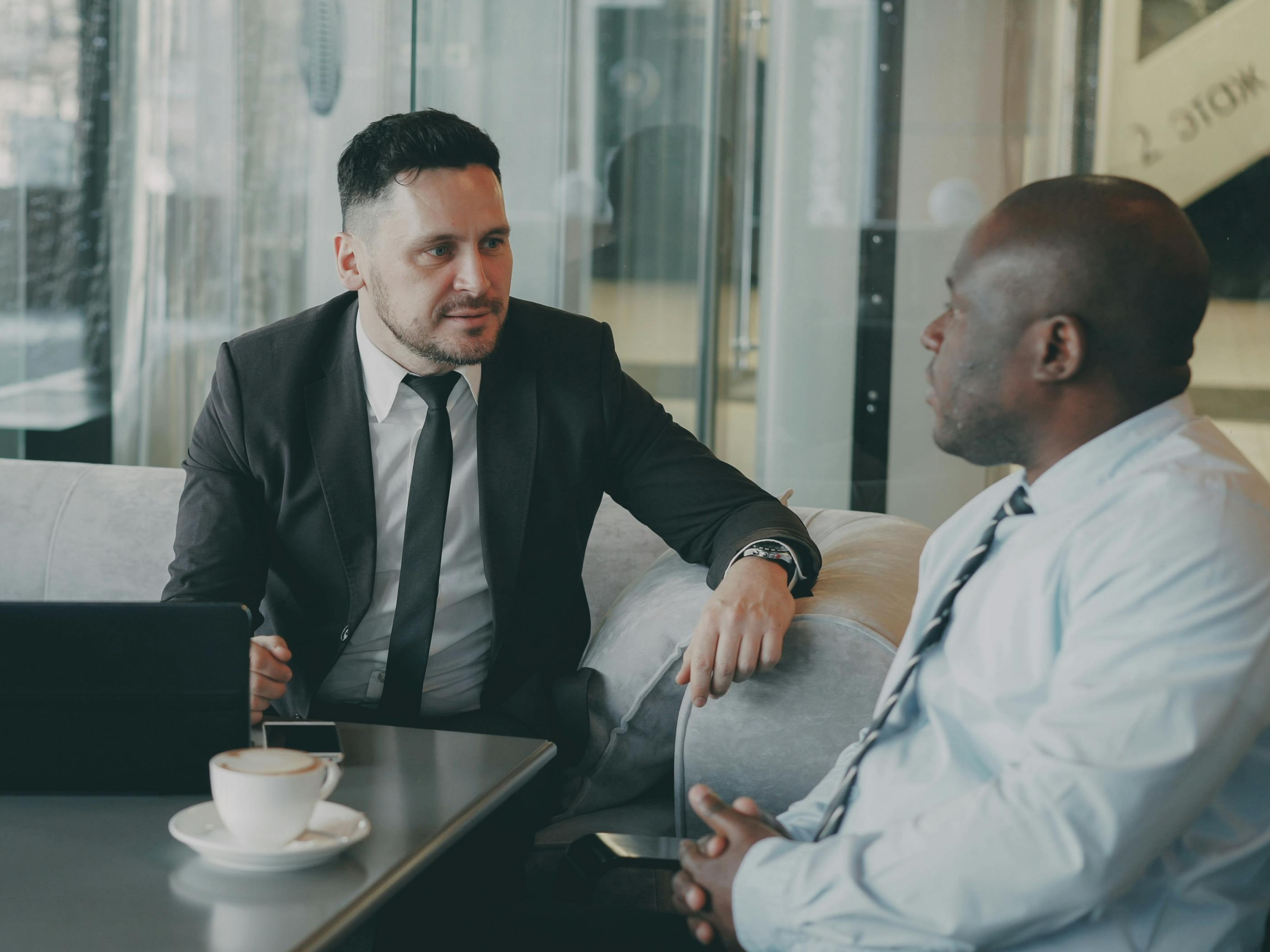 Two businessmen in a focused strategy meeting