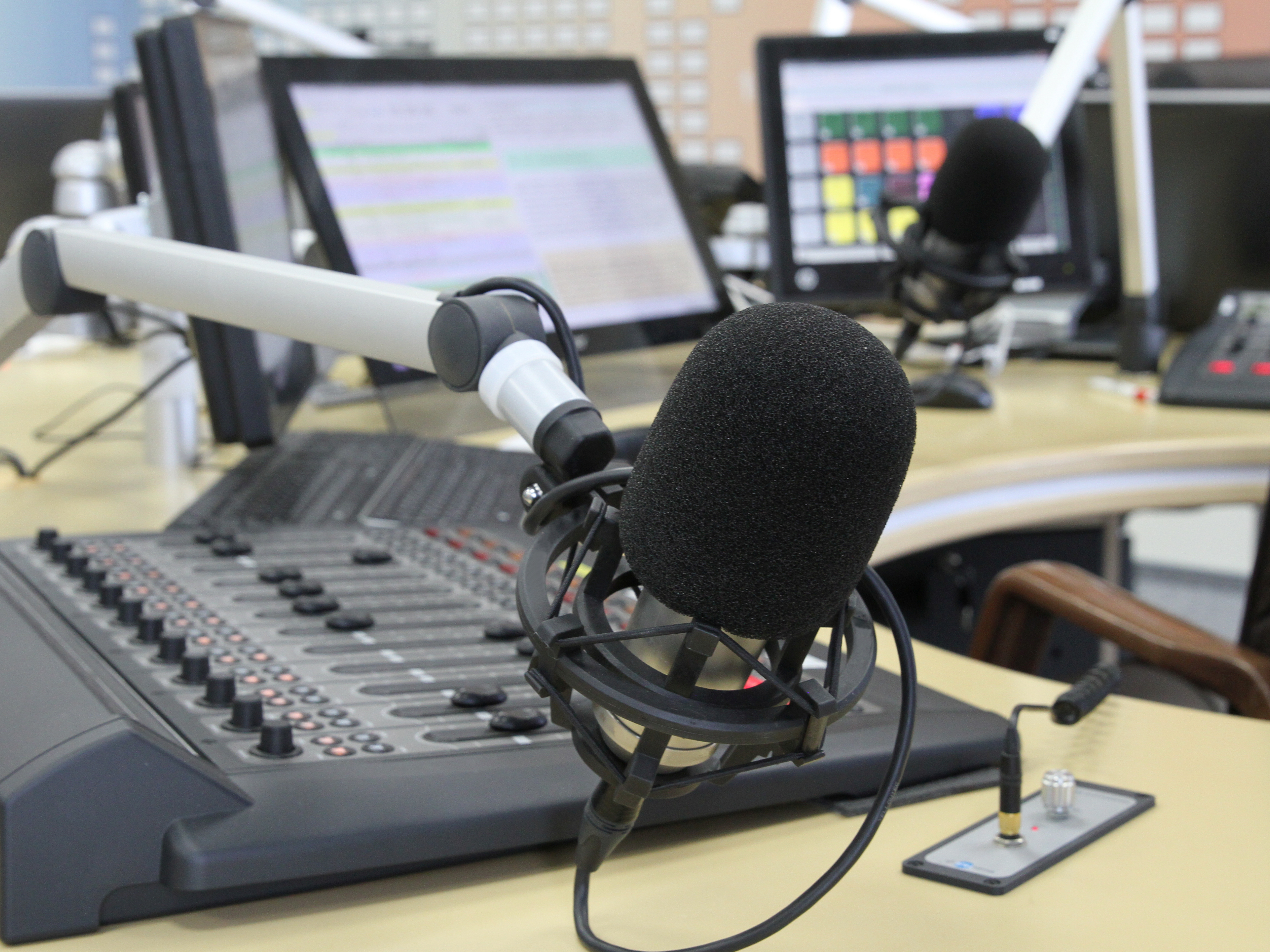 Professional broadcast desk with microphone and soundboard