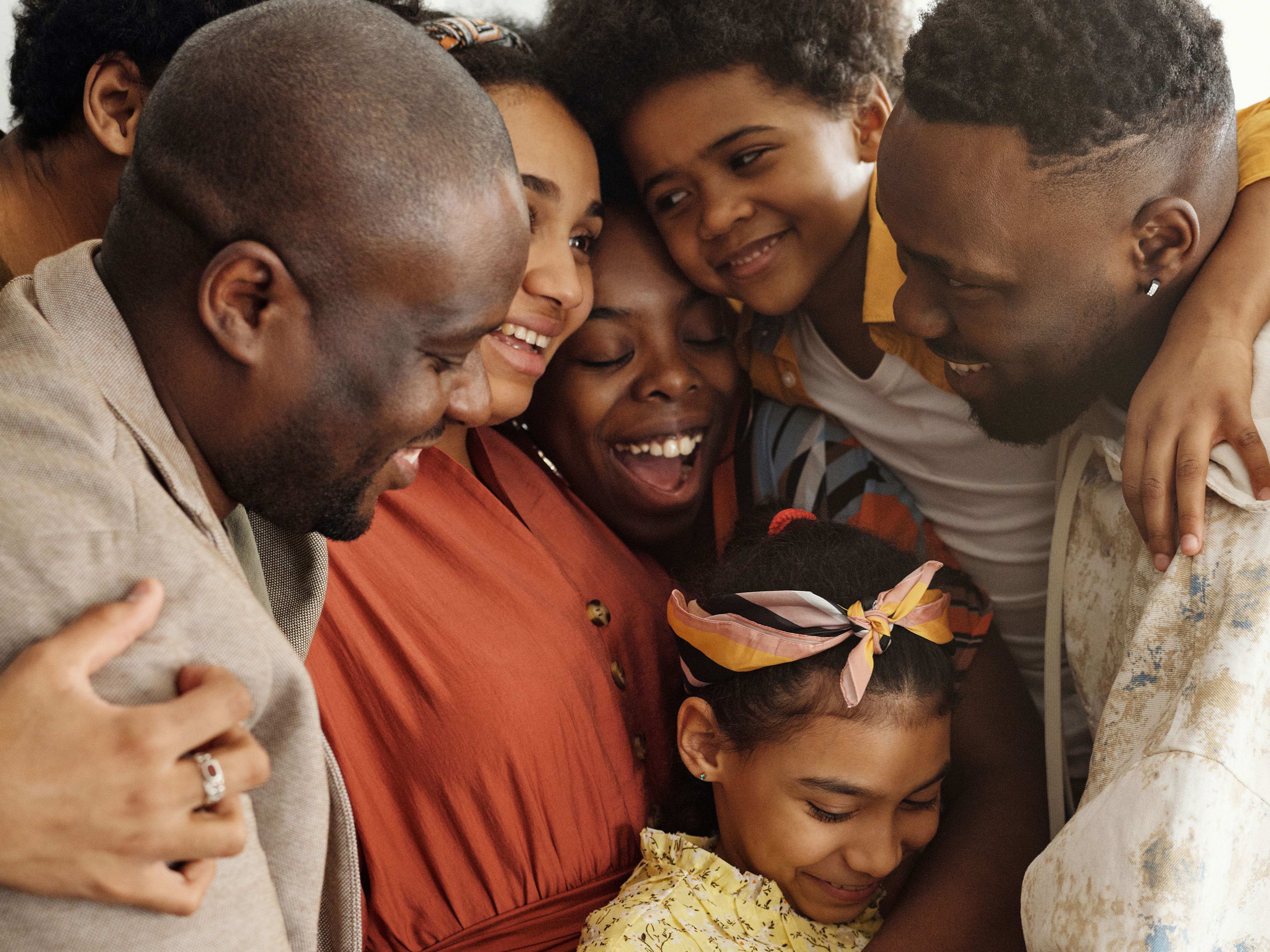Large multi-generational family in a joyful group hug