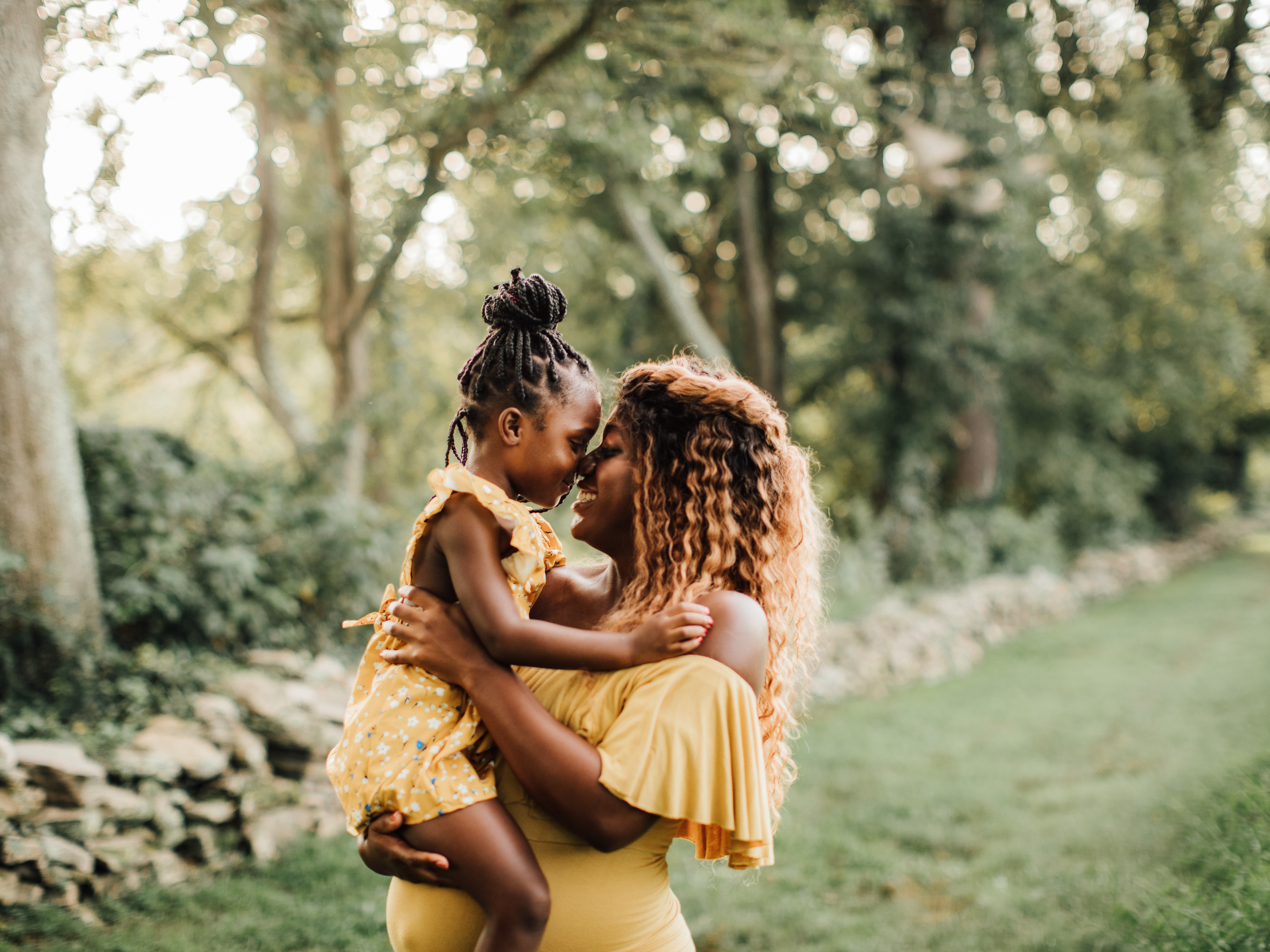 Mother and daughter sharing an affectionate outdoor moment