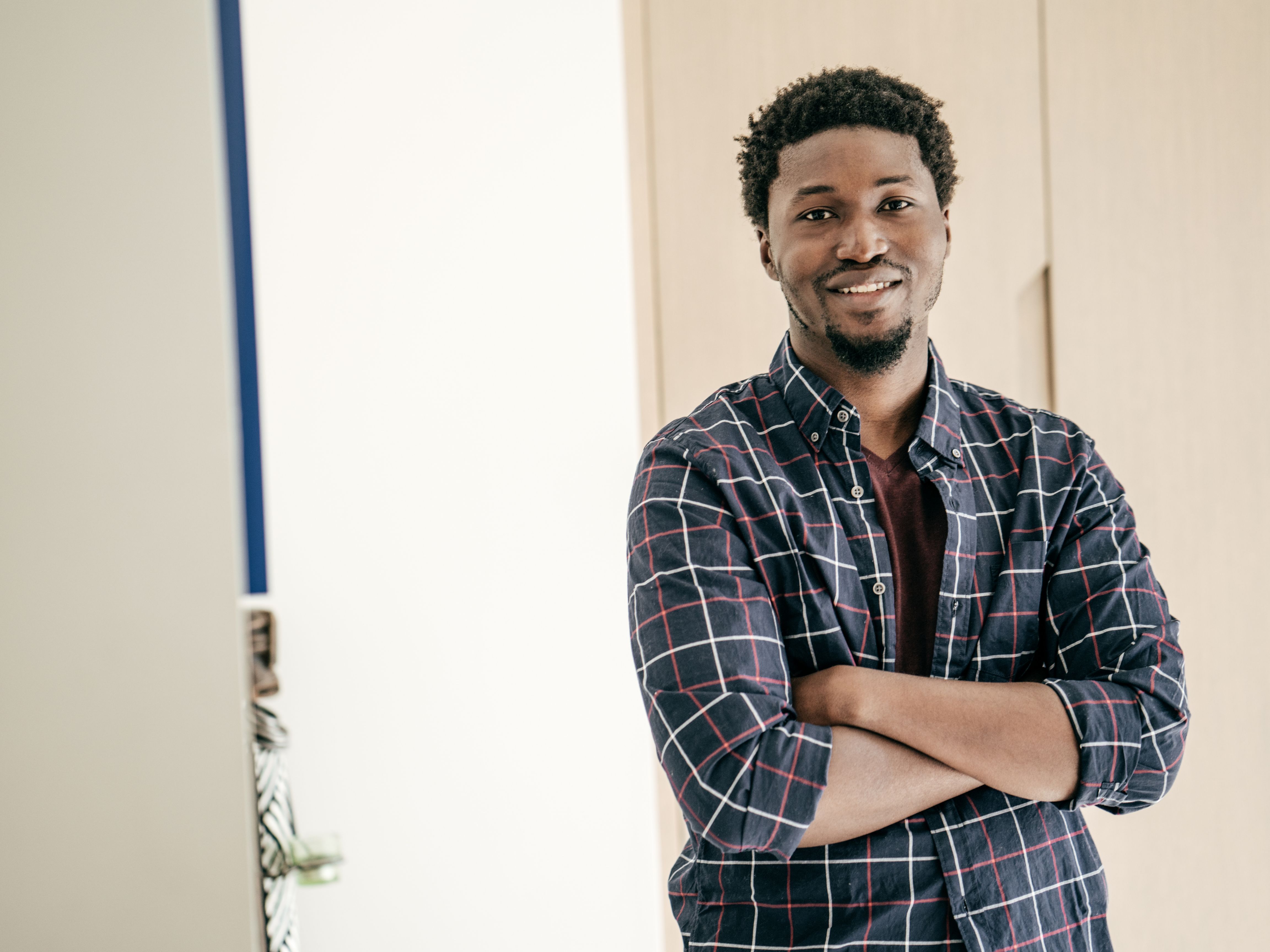 Confident young Black professional with arms crossed